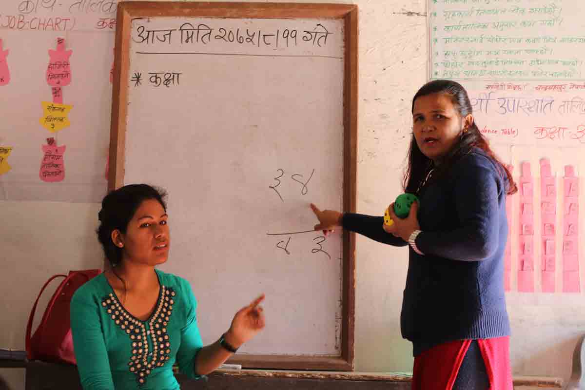 Teachers pointing on whiteboard